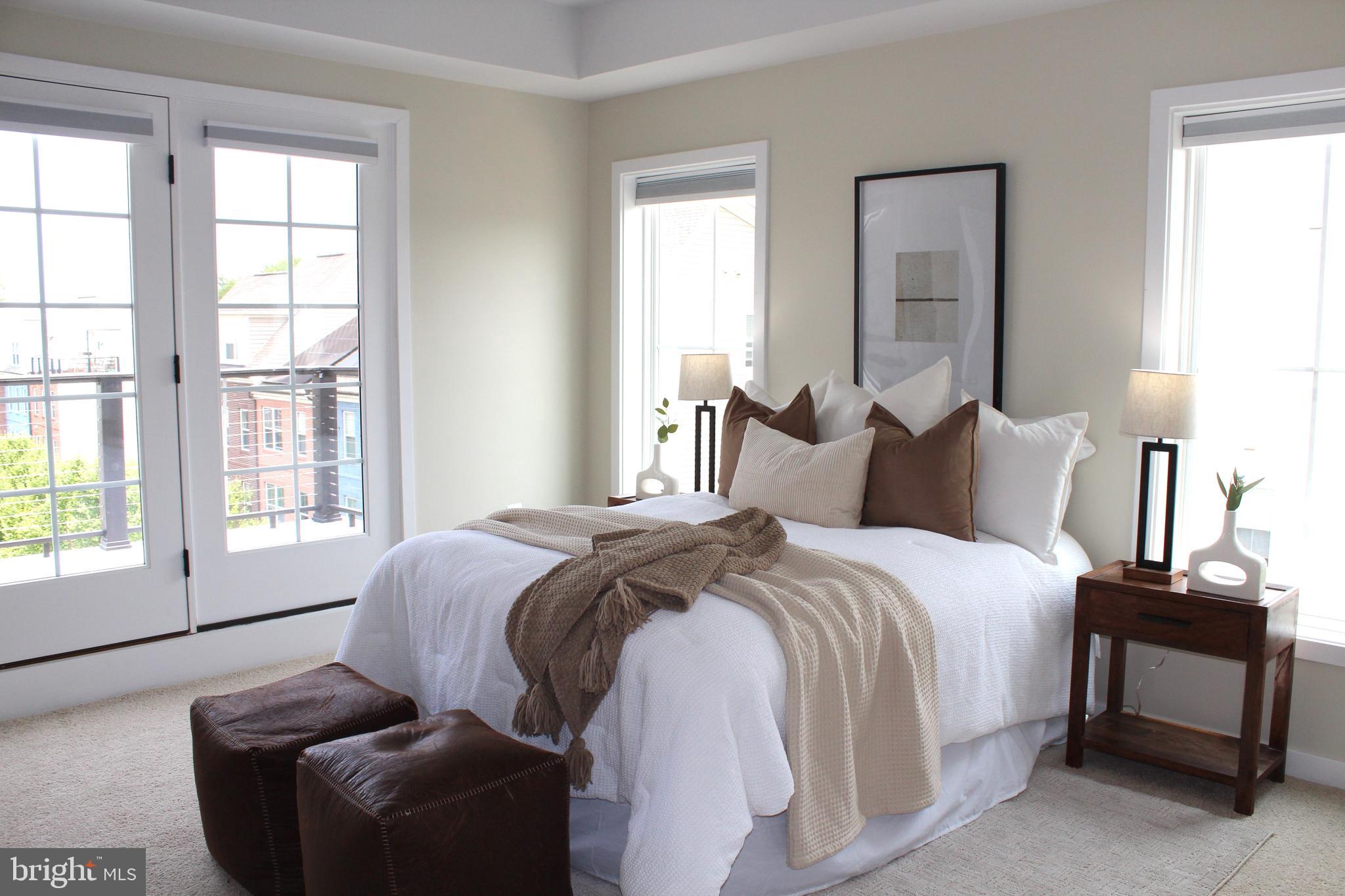 2411 Auden Drive Silver Spring, MD 20906 - Photo 20 of 45 a bedroom with a bed and a couch next to a window