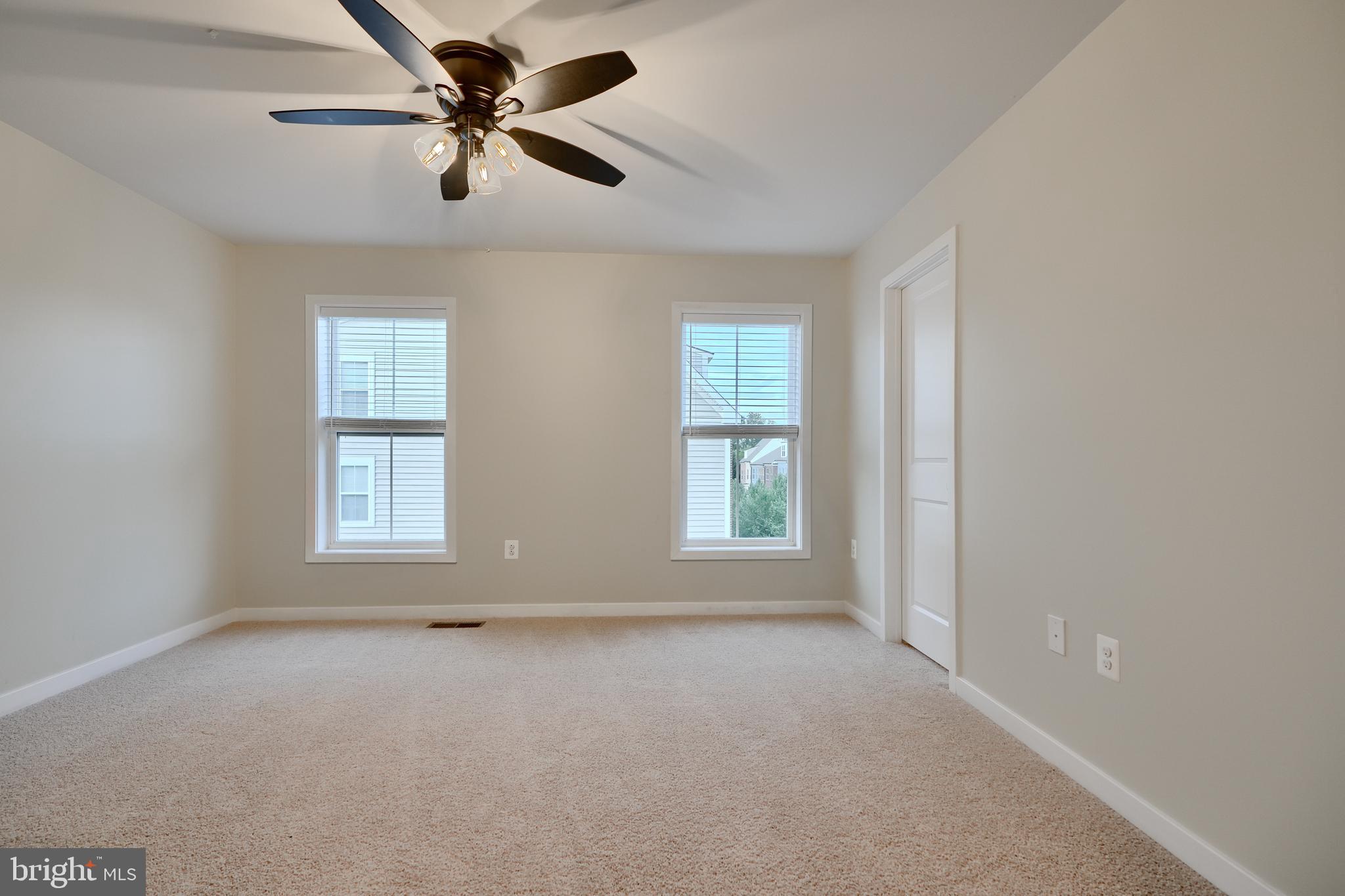 2411 Auden Drive Silver Spring, MD 20906 - Photo 29 of 45 an empty room with chandelier fan and windows