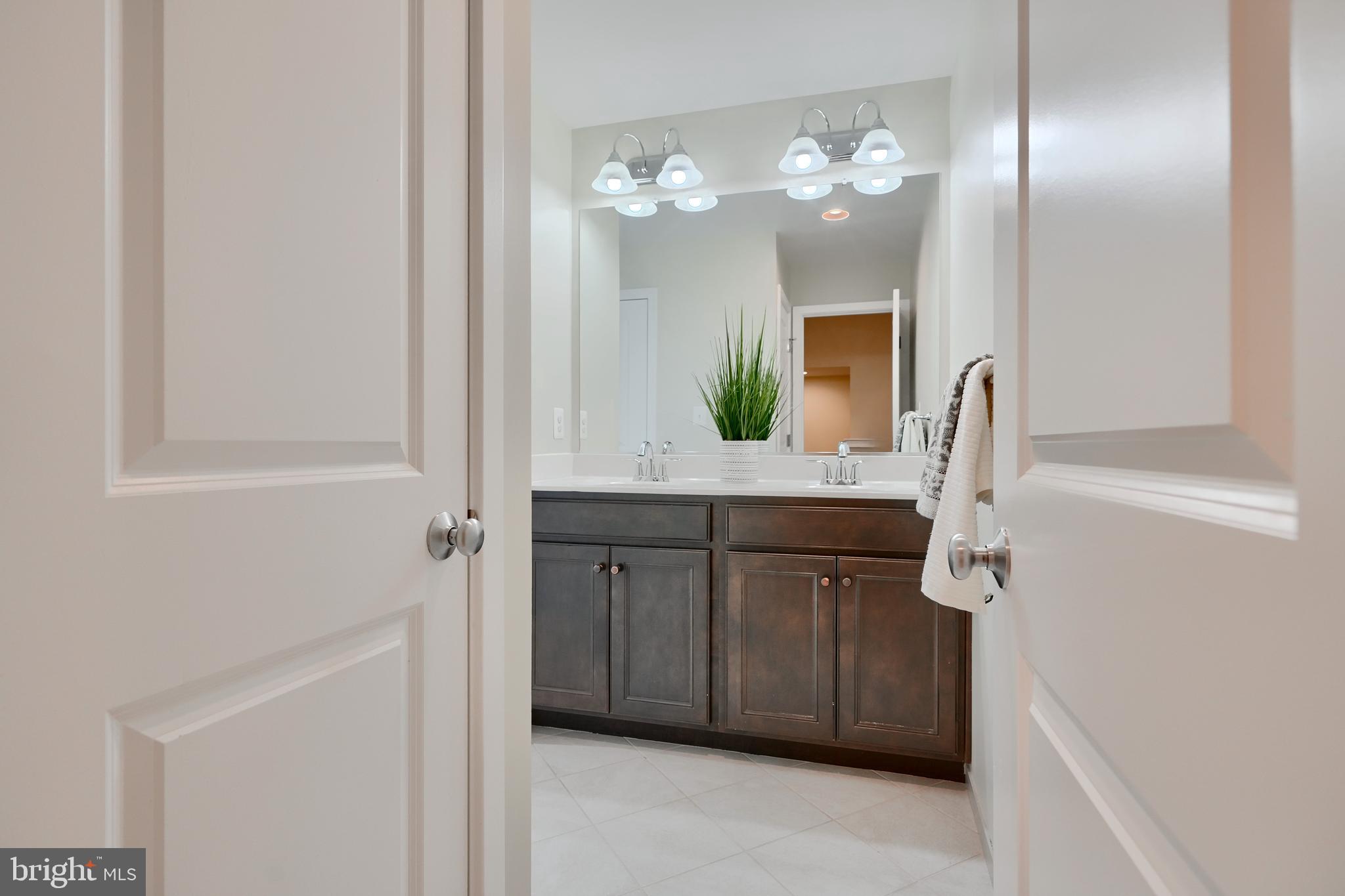 2411 Auden Drive Silver Spring, MD 20906 - Photo 33 of 45 a bathroom with a double vanity sink and a mirror