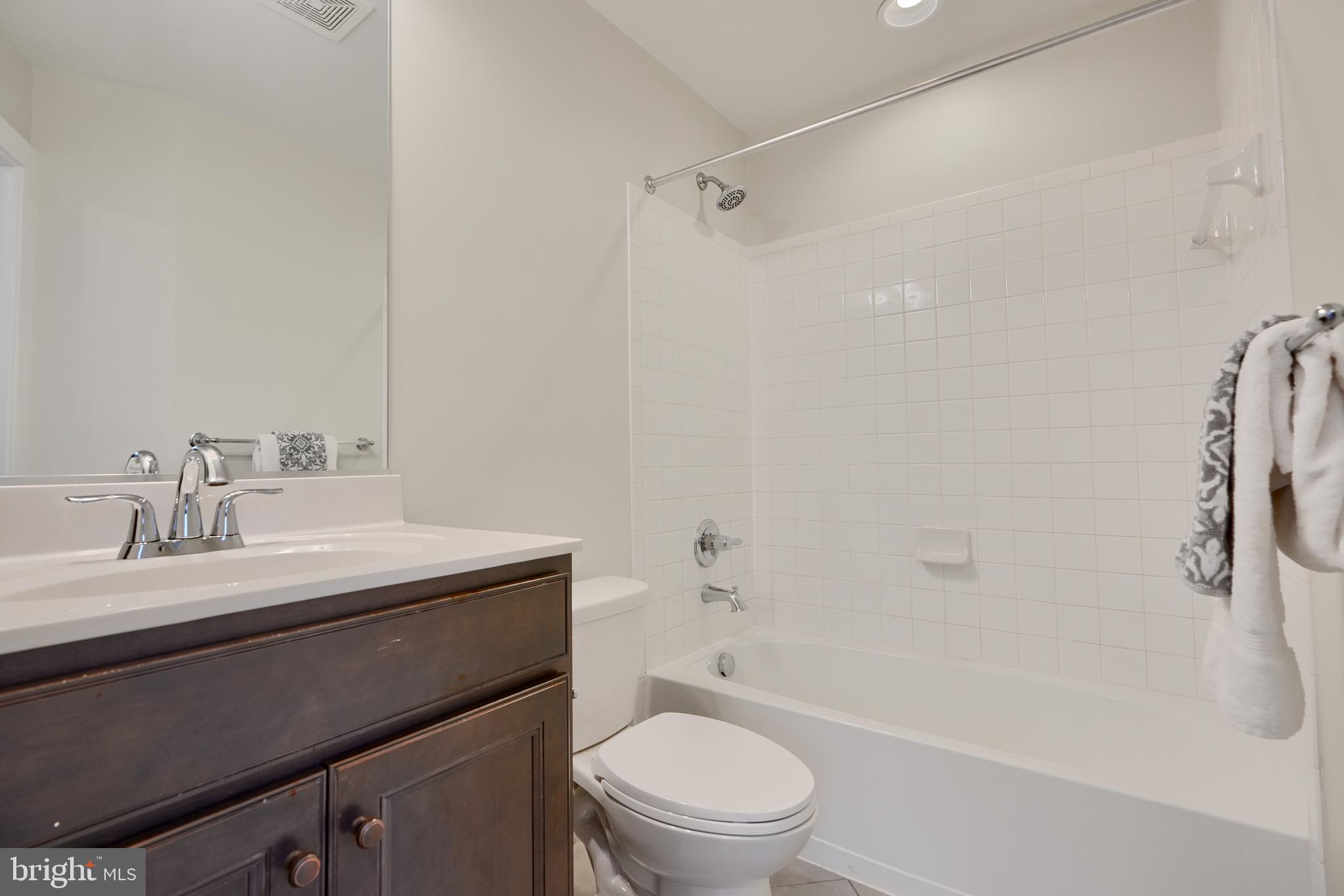 2411 Auden Drive Silver Spring, MD 20906 - Photo 9 of 45 a bathroom with a sink a toilet and a bathtub