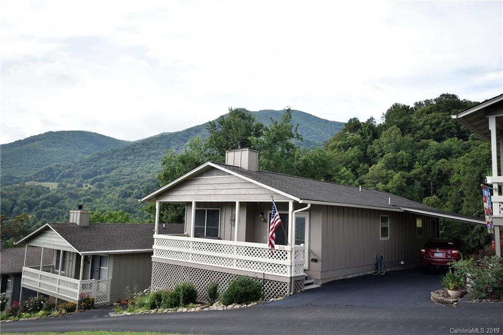 318 Stoney Ridge Loop Maggie Valley, NC 28751 - Photo 3 of 25 a front view of a house with a yard