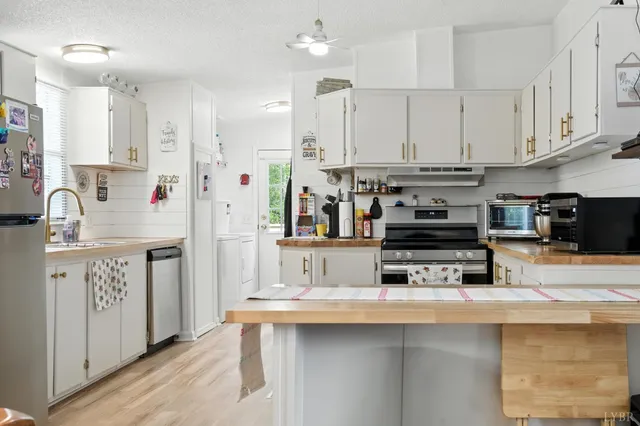 a kitchen with stainless steel appliances granite countertop a stove and cabinets