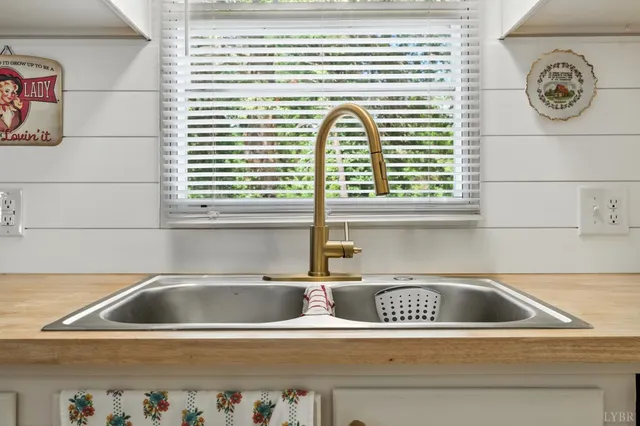 a kitchen with granite countertop a sink cabinets and stainless steel appliances