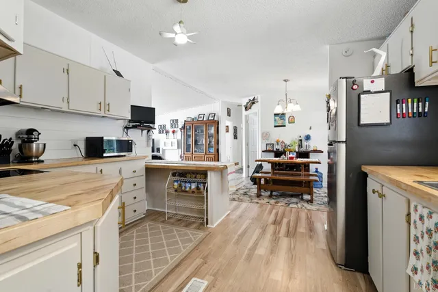 a kitchen with white cabinets and appliances