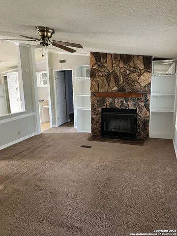 a view of empty room with a fireplace