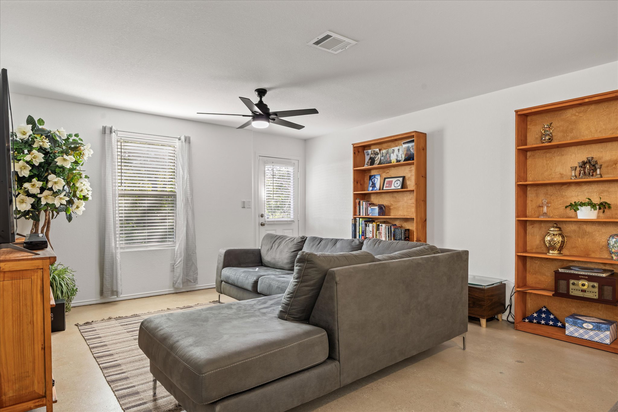 36 Trinity Circle Lockhart, TX 78644 - Photo 7 of 24 Polished concrete flooring paired with smooth walls anchors this versatile living area.