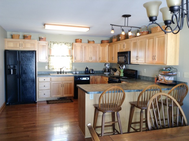 3529 East 2089th Road Serena, IL 60549 - Photo 2 of 19 a kitchen with granite countertop a stove a sink and a refrigerator