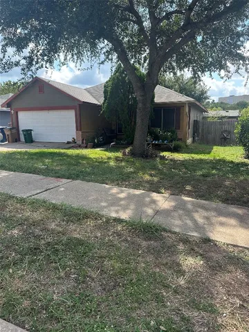 a view of a house with yard and a tree