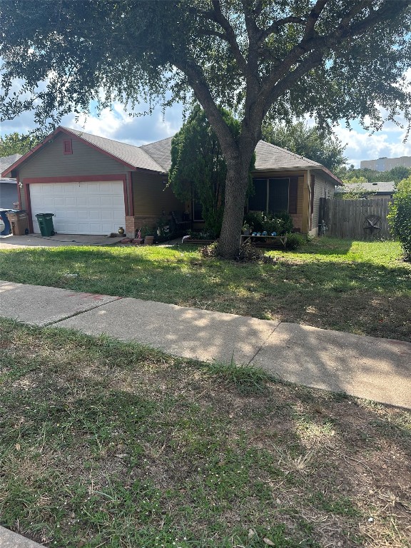 a view of a house with yard and a tree