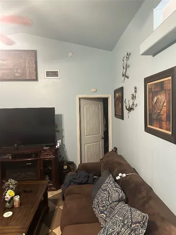 a bedroom with a bed and flat screen tv