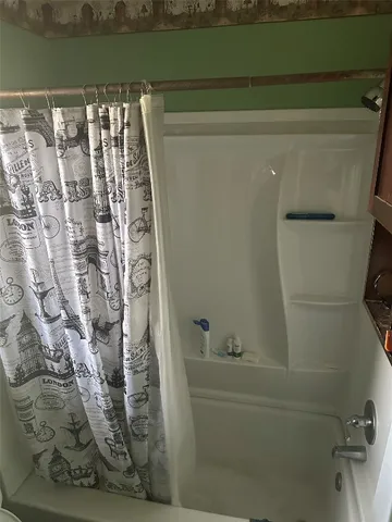 a bathroom with a bathtub and shower