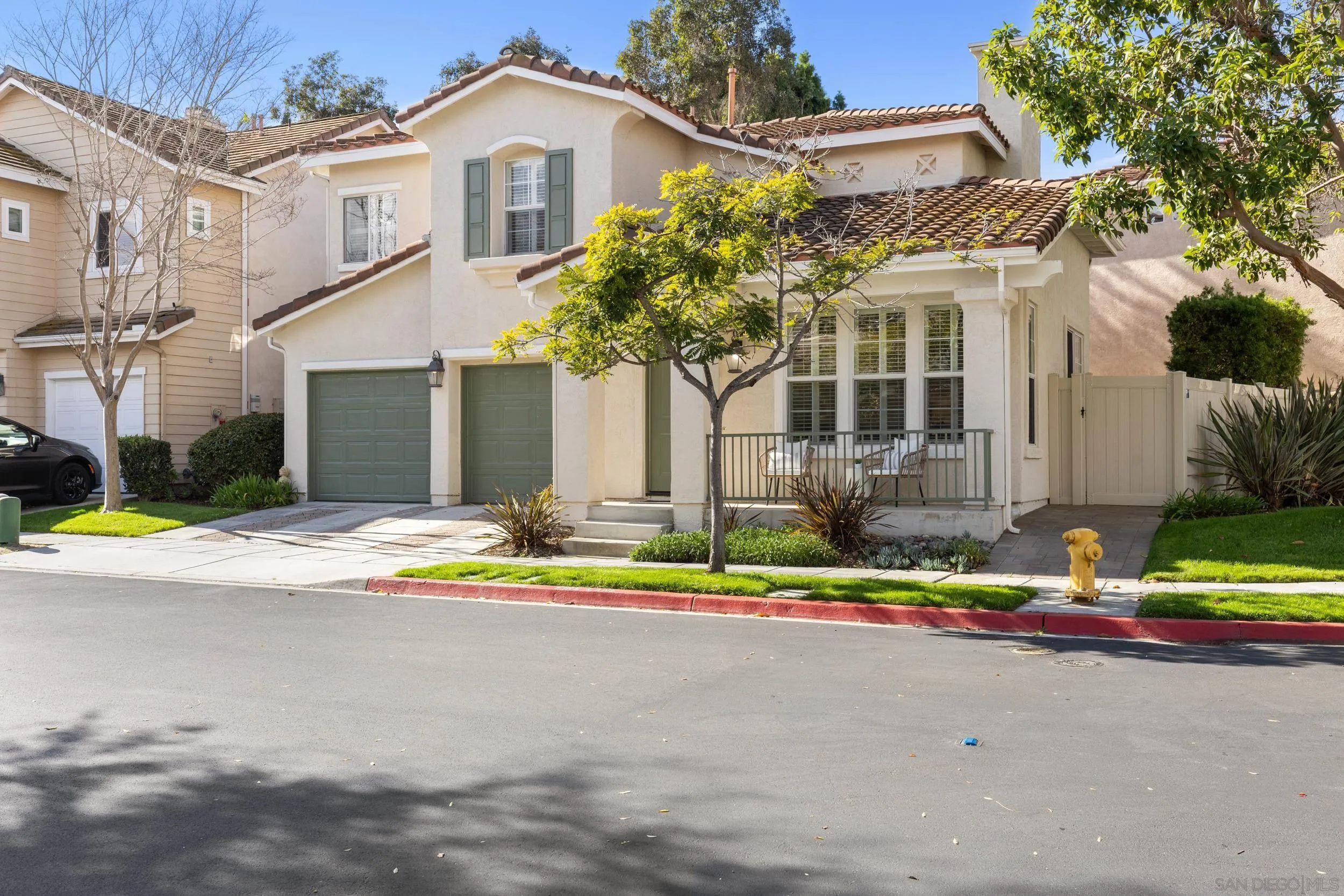 1126 Pacifica Place Encinitas, CA 92024 - Photo 17 of 18 a front view of a house with a yard and potted plants