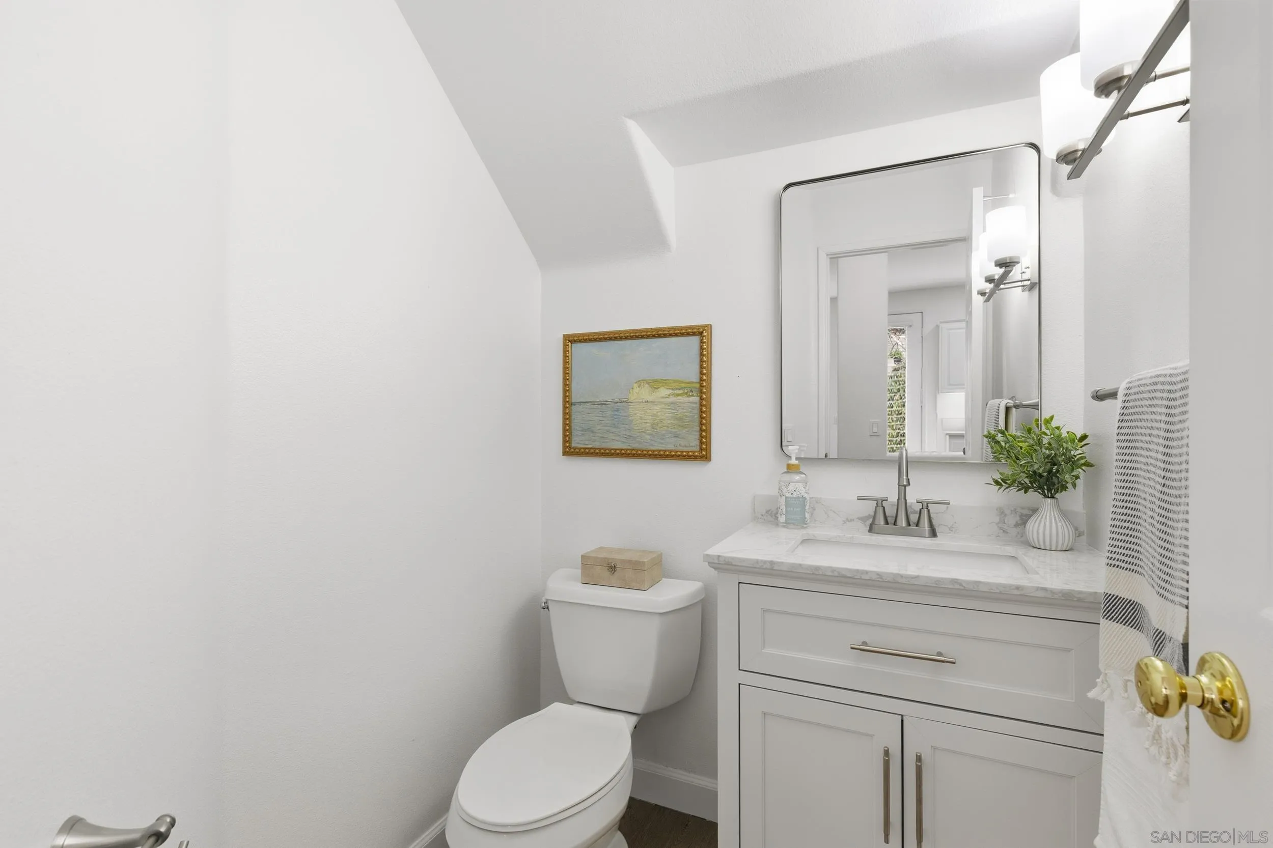 1126 Pacifica Place Encinitas, CA 92024 - Photo 8 of 18 a bathroom with a toilet sink and mirror