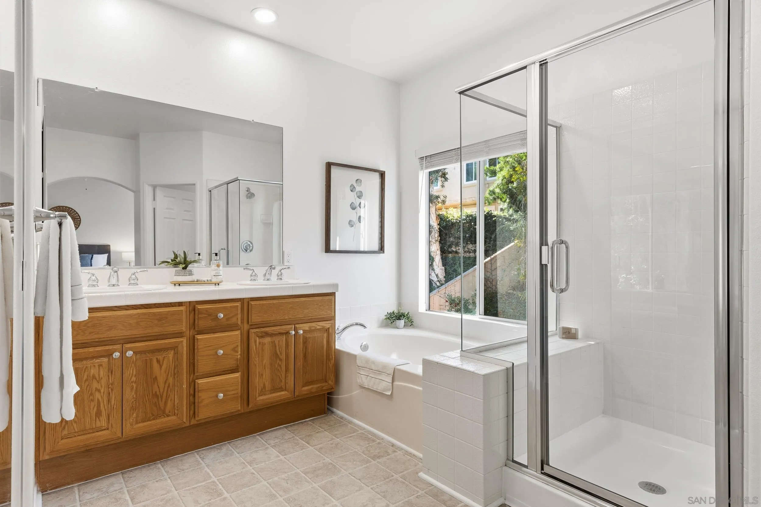 1126 Pacifica Place Encinitas, CA 92024 - Photo 10 of 18 a bathroom with a double vanity sink mirror and bathtub