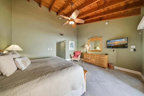a spacious bedroom with a bed and a chandelier