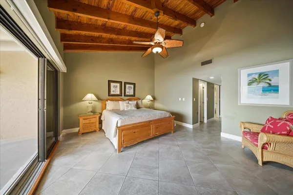 a spacious bedroom with a bed and a chandelier