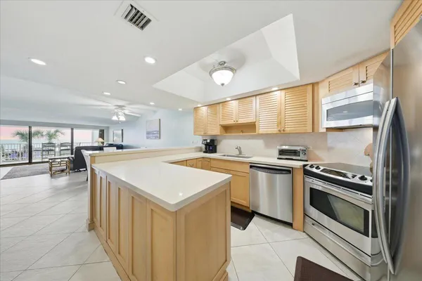 a kitchen with a stove sink and cabinets