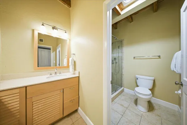 a bathroom with a toilet and a shower
