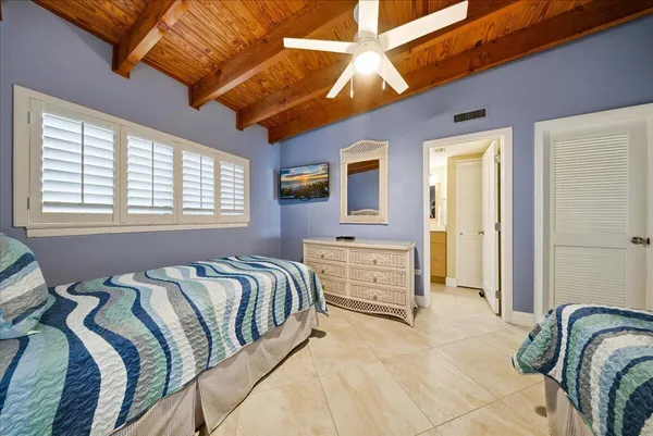 a bathroom with a bathtub shower sink vanity and mirror