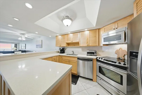 a kitchen with stainless steel appliances granite countertop a sink and a stove