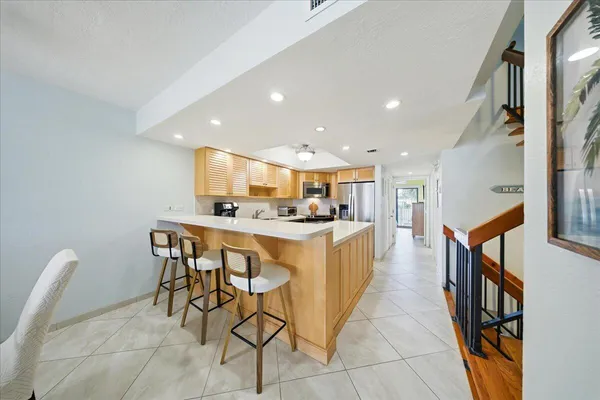 a open kitchen with stainless steel appliances kitchen island granite countertop a sink and cabinets
