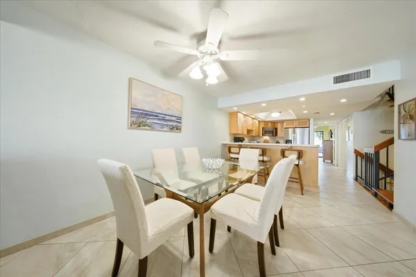 a dining room with furniture and a chandelier