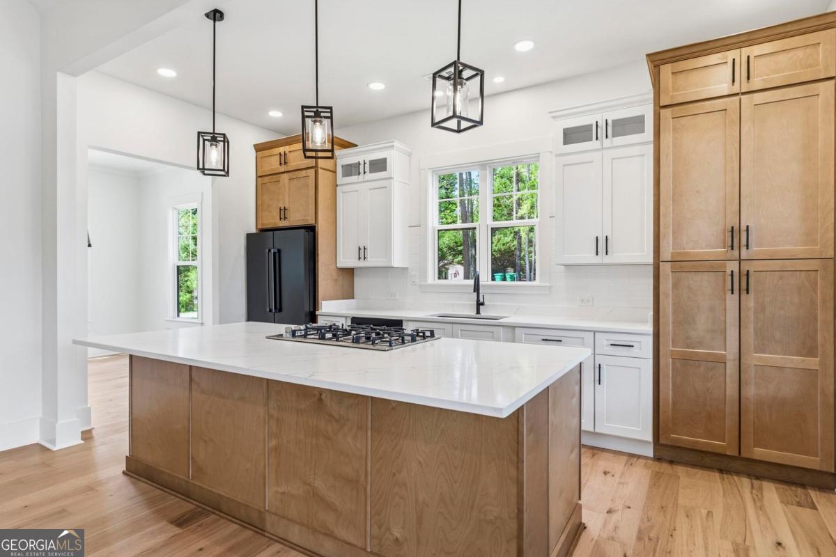 141 Grimes Road Northeast Milledgeville, GA 31061 - Photo 15 of 74 a kitchen with a refrigerator a sink and wooden floor