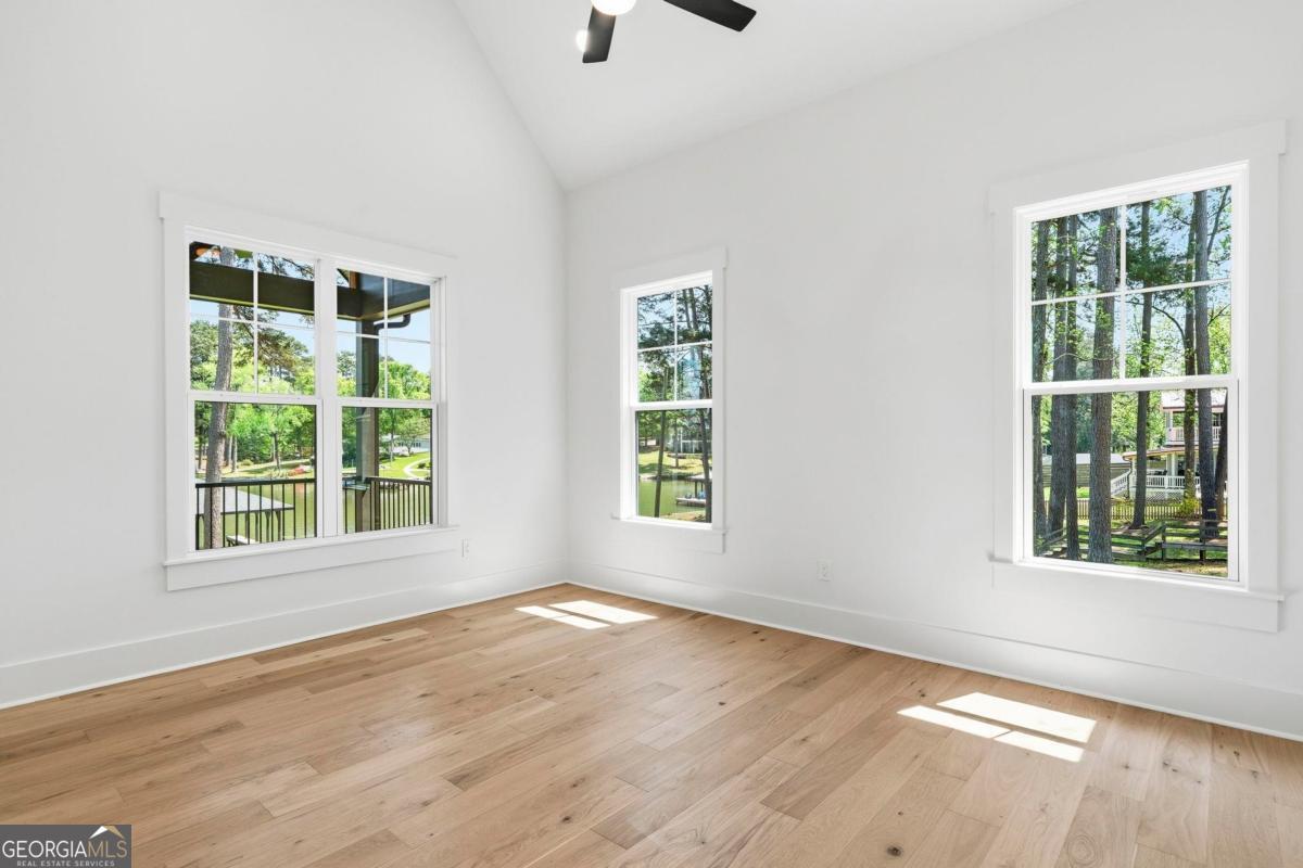 141 Grimes Road Northeast Milledgeville, GA 31061 - Photo 27 of 74 an empty room with wooden floor and windows