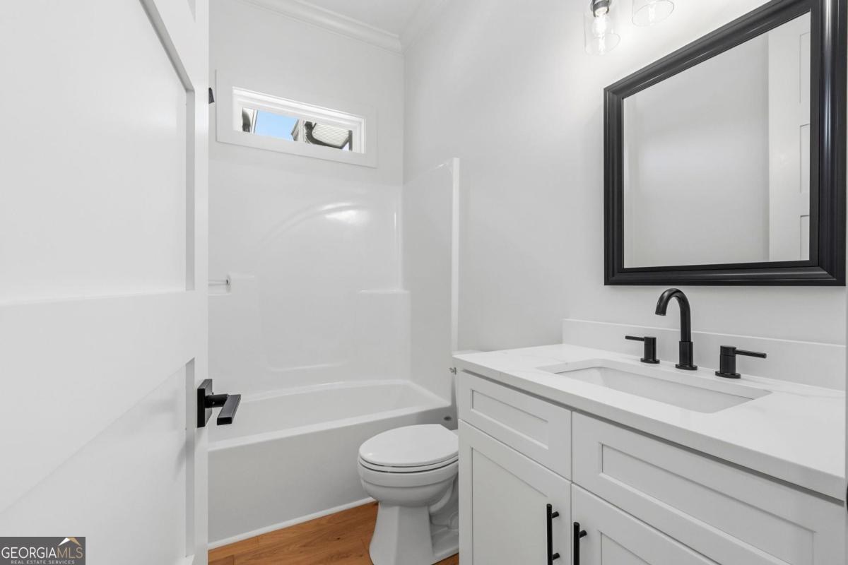 141 Grimes Road Northeast Milledgeville, GA 31061 - Photo 39 of 74 a bathroom with a sink a toilet and shower