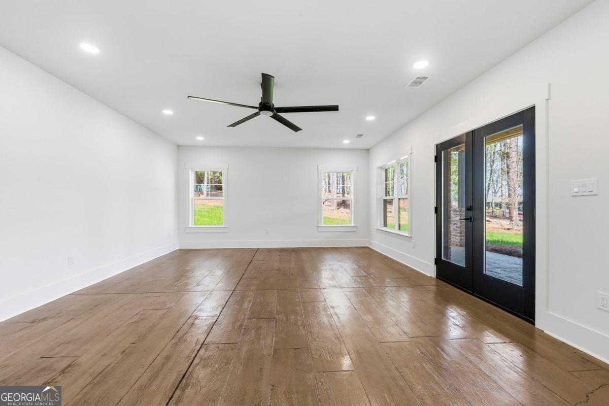 141 Grimes Road Northeast Milledgeville, GA 31061 - Photo 41 of 74 a view of an empty room with window and wooden floor