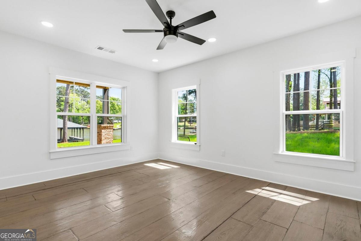 141 Grimes Road Northeast Milledgeville, GA 31061 - Photo 46 of 74 a view of an empty room with a window and wooden floor