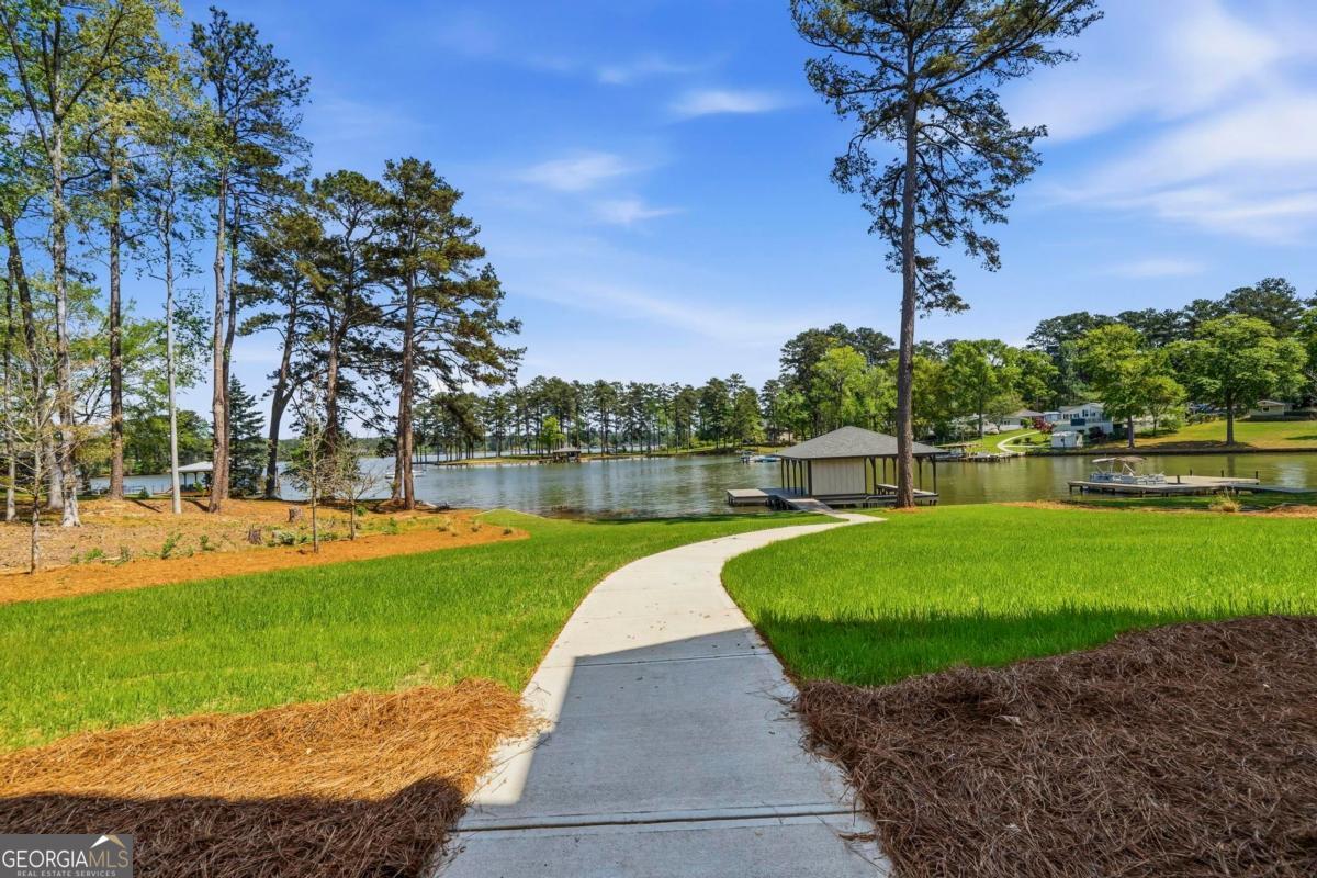 141 Grimes Road Northeast Milledgeville, GA 31061 - Photo 55 of 74 a view of a garden with water fountain and a large tree