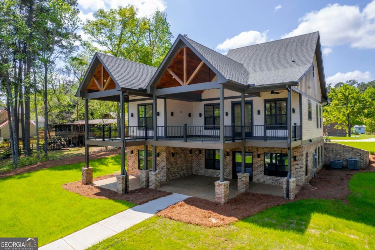 141 Grimes Road Northeast Milledgeville, GA 31061 - Photo 57 of 74 a view of a house with swimming pool and a yard
