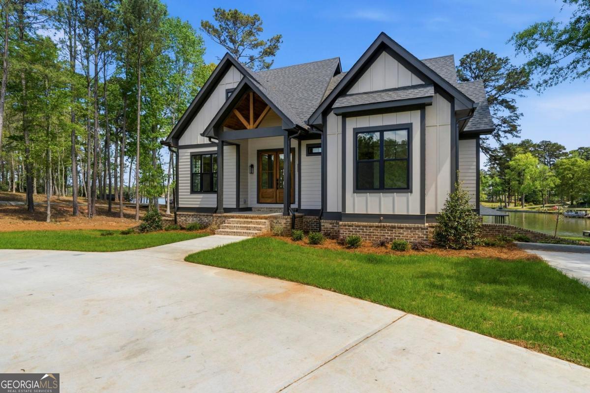 141 Grimes Road Northeast Milledgeville, GA 31061 - Photo 59 of 74 a front view of a house with a yard and garage