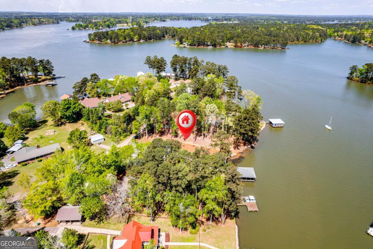 141 Grimes Road Northeast Milledgeville, GA 31061 - Photo 65 of 74 an aerial view of residential houses with outdoor space and lake view