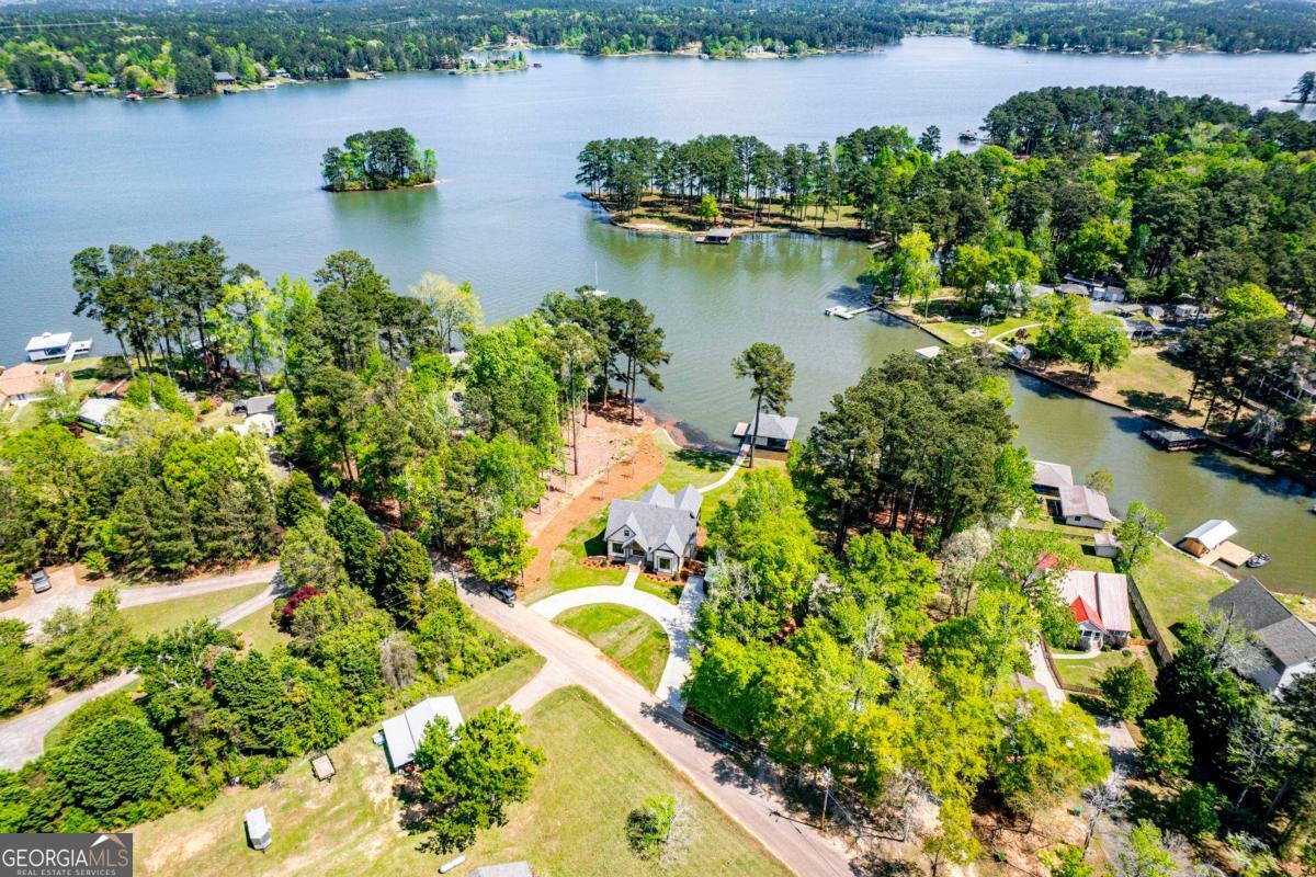 141 Grimes Road Northeast Milledgeville, GA 31061 - Photo 70 of 74 an aerial view of lake residential house with outdoor space and trees around