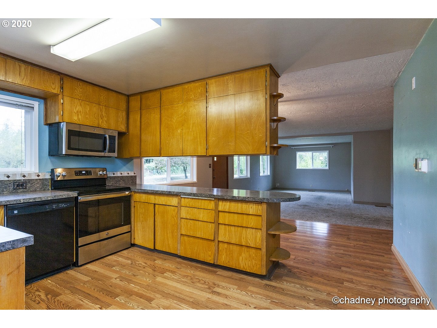 33833 Southeast Hurlburt Road Corbett, OR 97019 - Photo 11 of 32 a kitchen with stainless steel appliances granite countertop a stove top oven a sink dishwasher and cabinets with wooden floor