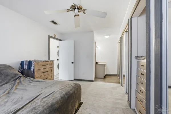 a bedroom with furniture and a chandelier