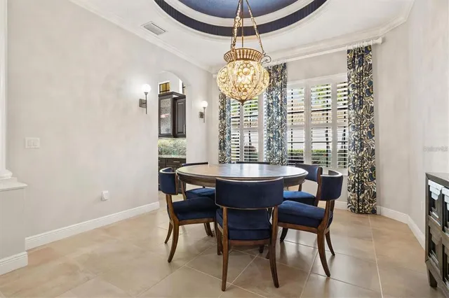 a view of a dining room with furniture and chandelier
