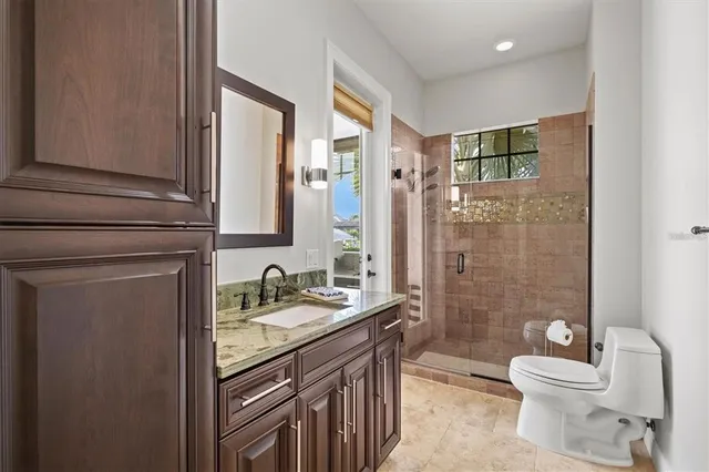 a bedroom with a bed and a ceiling fan