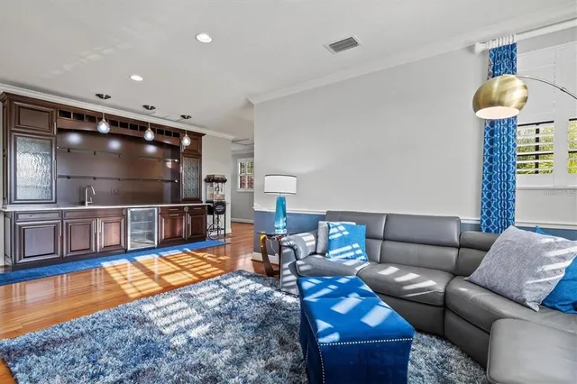 a view of a patio with couches table and chairs with potted plants