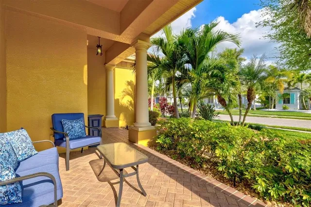 a view of a house with a large windows and flower plants