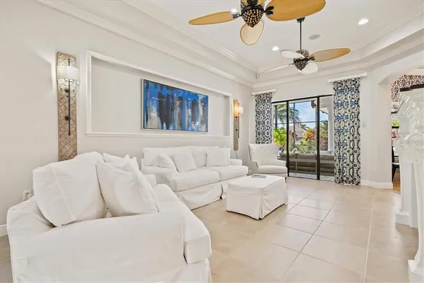 a living room with furniture a clock and a fireplace