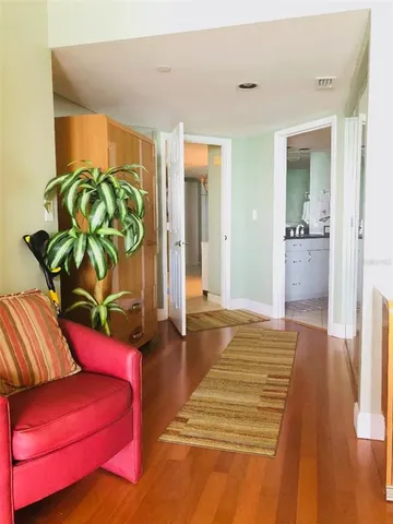 a bedroom with a bed table and a chair