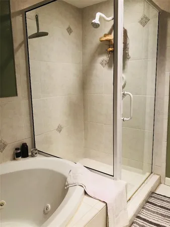 a bathroom with a tub and a shower