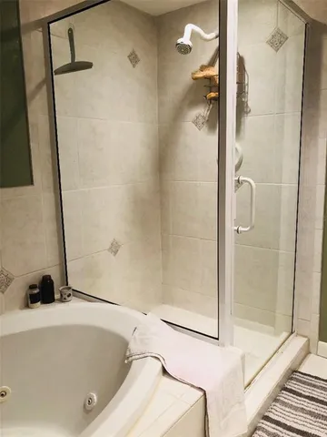 a bathroom with a tub and a shower