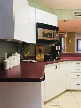 a kitchen with stainless steel appliances granite countertop a stove a microwave and a refrigerator