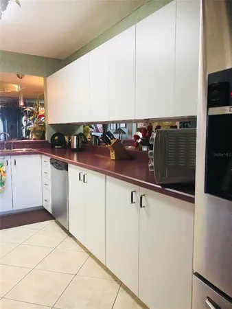 a kitchen with stainless steel appliances a sink and cabinets