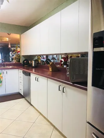 a kitchen with stainless steel appliances a sink and cabinets