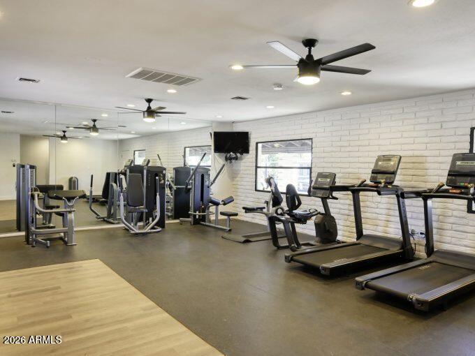 5201 West Camelback Road, Unit C107 Phoenix, AZ 85031 - Photo 11 of 12 a room with gym equipment and large mirror
